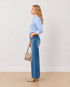 Dede blue and white striped cotton shirt with sleeves rolled back, side profile view