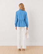 Delta light blue denim peplum shirt, back view of the long oversized length