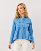 Delta light blue 100% cotton peplum shirt, waist up front view with hidden dignity buttons
