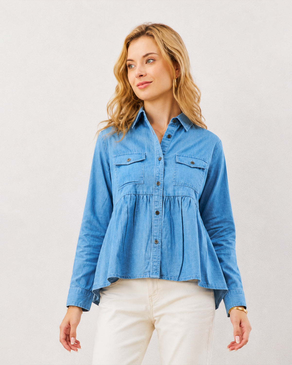 Delta light blue 100% cotton peplum shirt, waist up front view with hidden dignity buttons