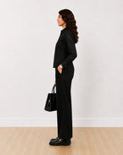 Desire black denim shirt, side profile view of the long curved hem
