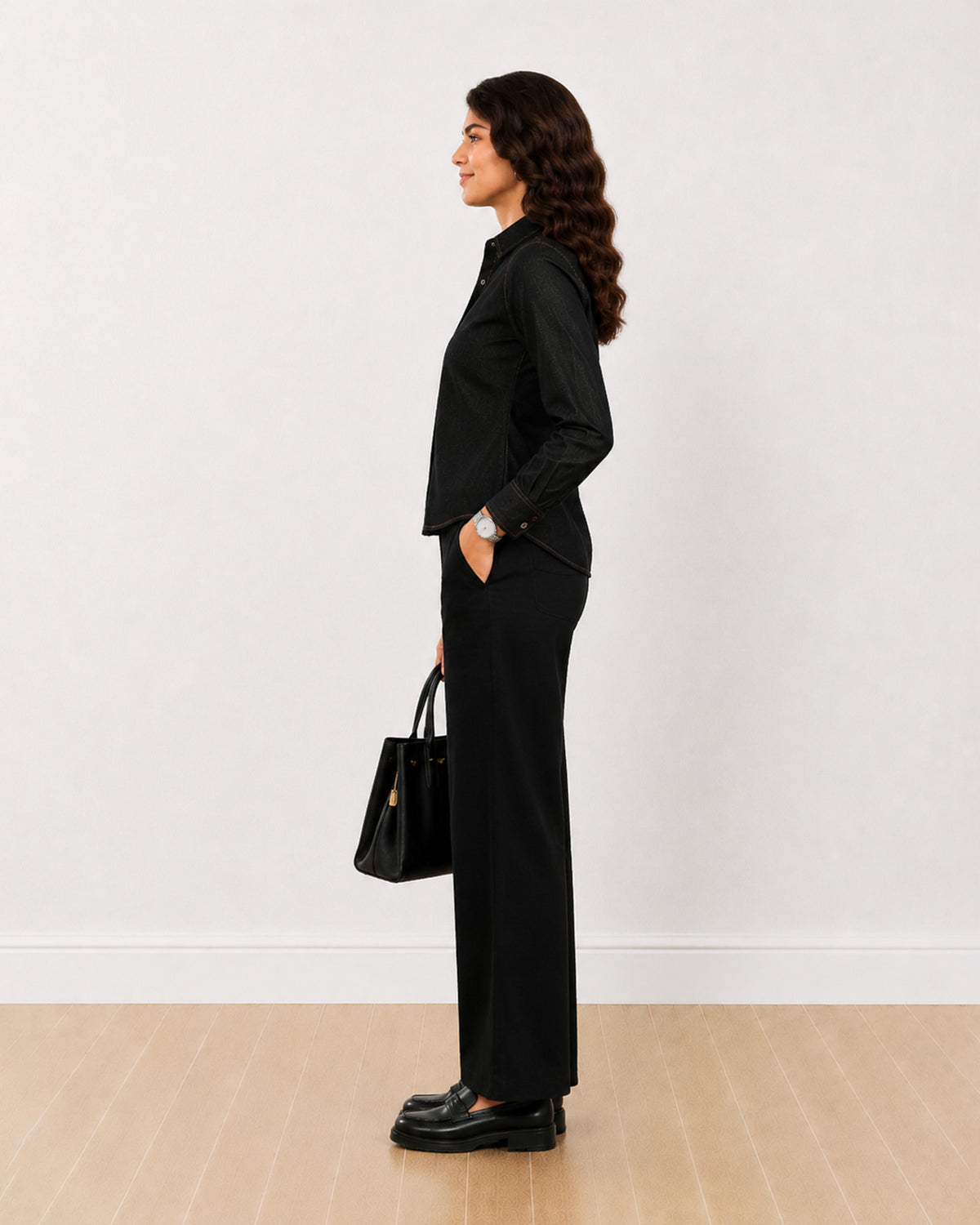 Desire black denim shirt, side profile view of the long curved hem
