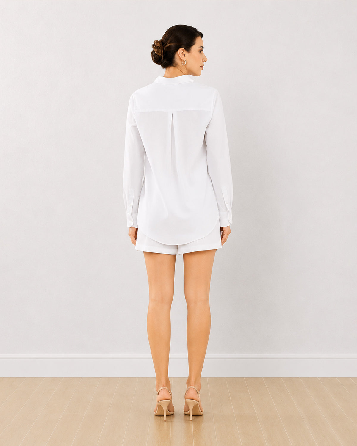 Destiny white embroidered co-ord set, back view of the long curved hem shirt
