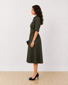 Diana olive green cotton midi shirt dress, side profile view of the mid calf length