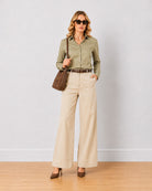 Diane beige mid waist formal trousers, angled front view of the wide leg fit