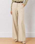 Diane beige formal trousers, waist down front view with hand in side cross pocket