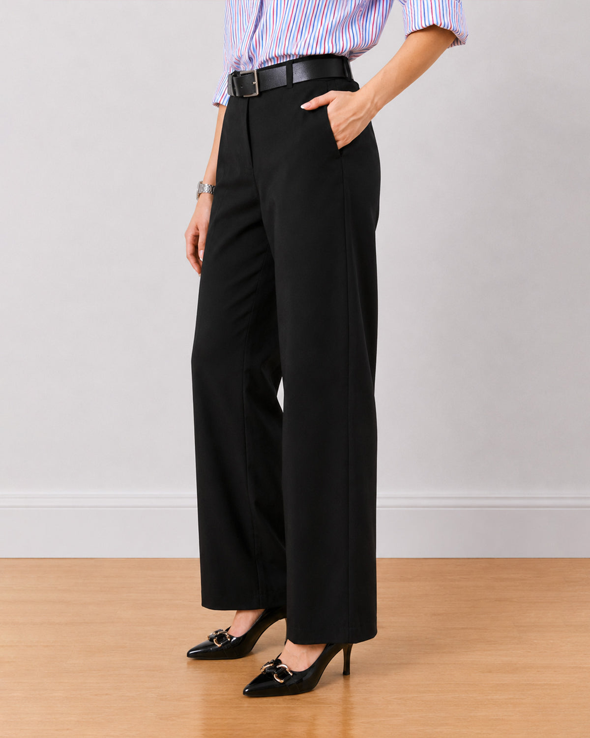 Diane black formal trousers, waist down angled view with hand in the side cross pocket