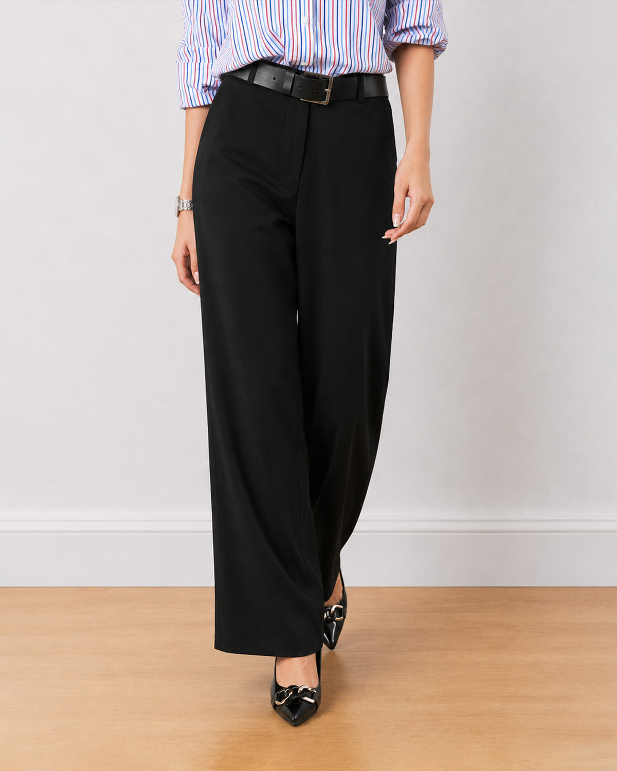 Diane black formal trousers, waist down front view of the mid waist wide leg fit
