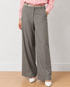 Diane grey formal trousers, waist down front view with hand in the side cross pocket