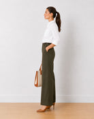 Diane olive green formal trousers, side profile view of the full length wide leg