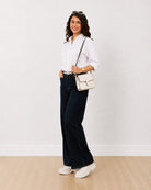Dill white self striped oversized shirt, angled walking front view with rolled sleeves