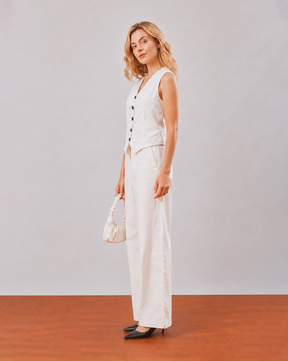 Dina white cotton linen vest co-ord set, angled front view of the waist length vest