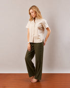 Doll beige short sleeves shirt, curve friendly angled walking front view worn untucked
