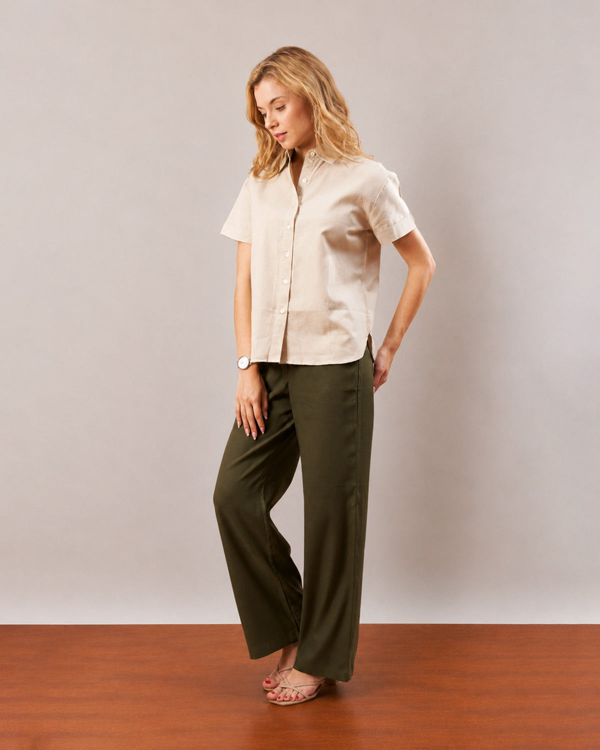 Doll beige short sleeves shirt, curve friendly angled walking front view worn untucked