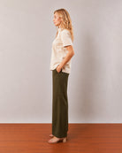 Doll beige short sleeves shirt, side profile view of the boxy fit and curved hem