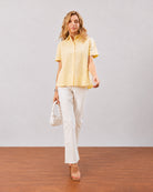 Doll lemon yellow short sleeves shirt, full length walking front view worn untucked