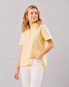 Doll lemon yellow short sleeves shirt, curve friendly close up front view with hand on hip