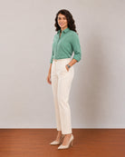 Dora emerald green formal shirt, angled front view with sleeves rolled to the elbow