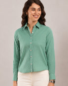 Dora emerald green cotton linen formal shirt, waist up front view worn tucked in