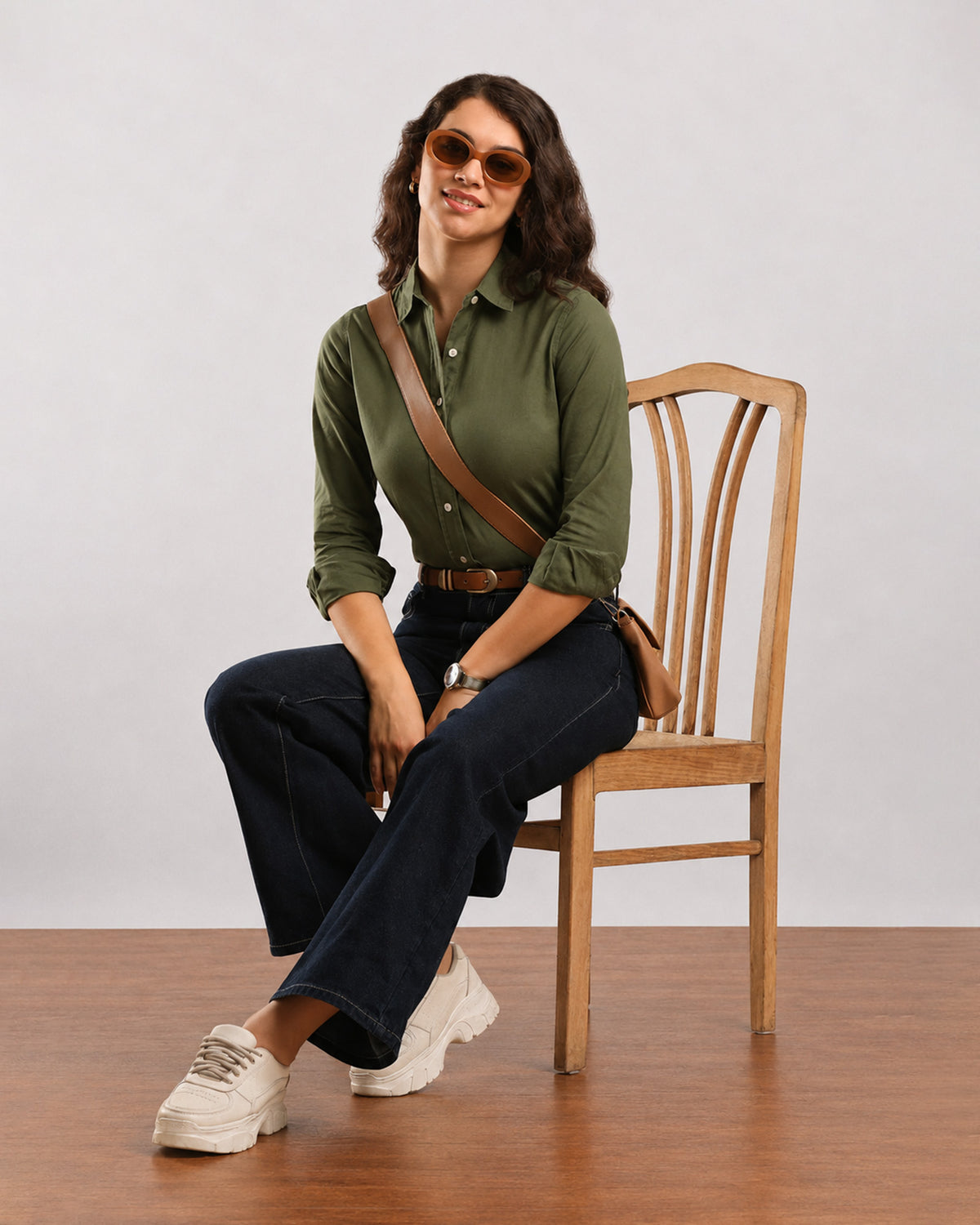 Dora olive green formal shirt, seated angled view with sleeves rolled to the elbow