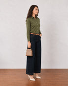 Dora olive green cotton linen shirt, side profile view with sleeves rolled up