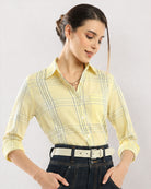 Close-up of Earnia yellow checks shirt shoulder seam and front placket buttons