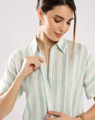 Close-up of Elle sage green stripes shirt button placket and dignity buttons