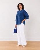Ellie dark blue cotton shirt with a curved hem and 3/4 puff sleeves, angled front view