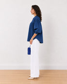 Ellie dark blue cotton shirt with all-round gathers, side profile view