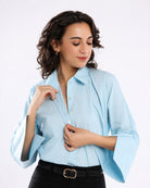 Close-up of Emery sky blue shirt broad cuff, button placket and dignity buttons