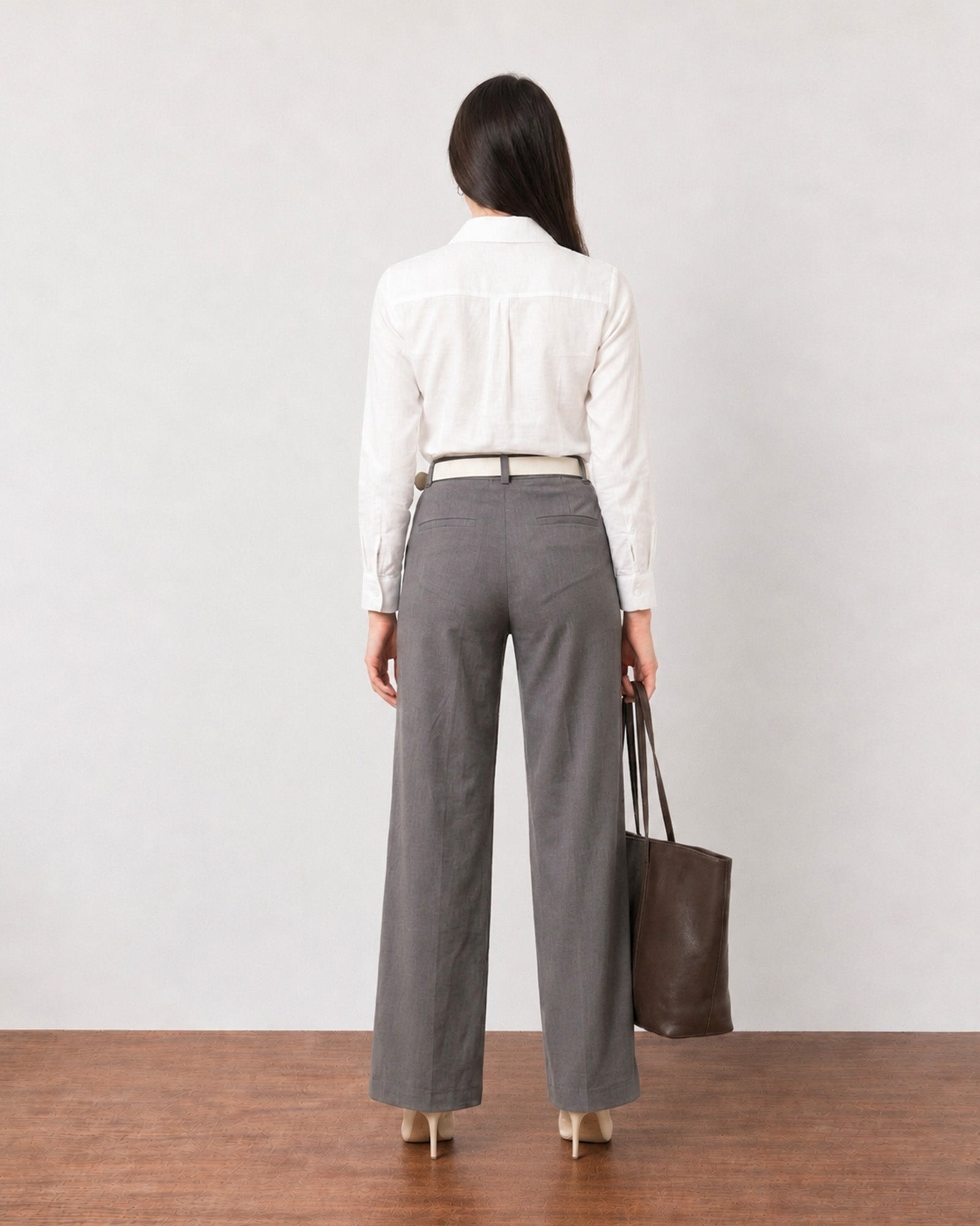 Gabriela charcoal grey linen pants with cotton voile lining, back view with welt pockets