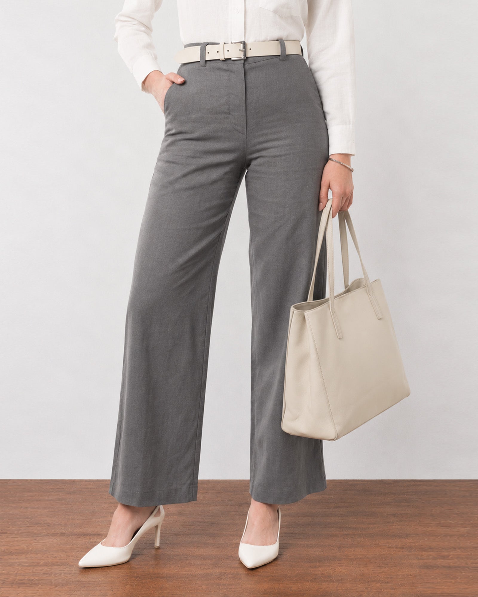 Close-up of Gabriela charcoal grey linen pants waistband, belt loops and side pocket
