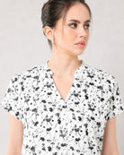 Close-up of Galia black and white floral top notched V-neckline and inverted centre pleat