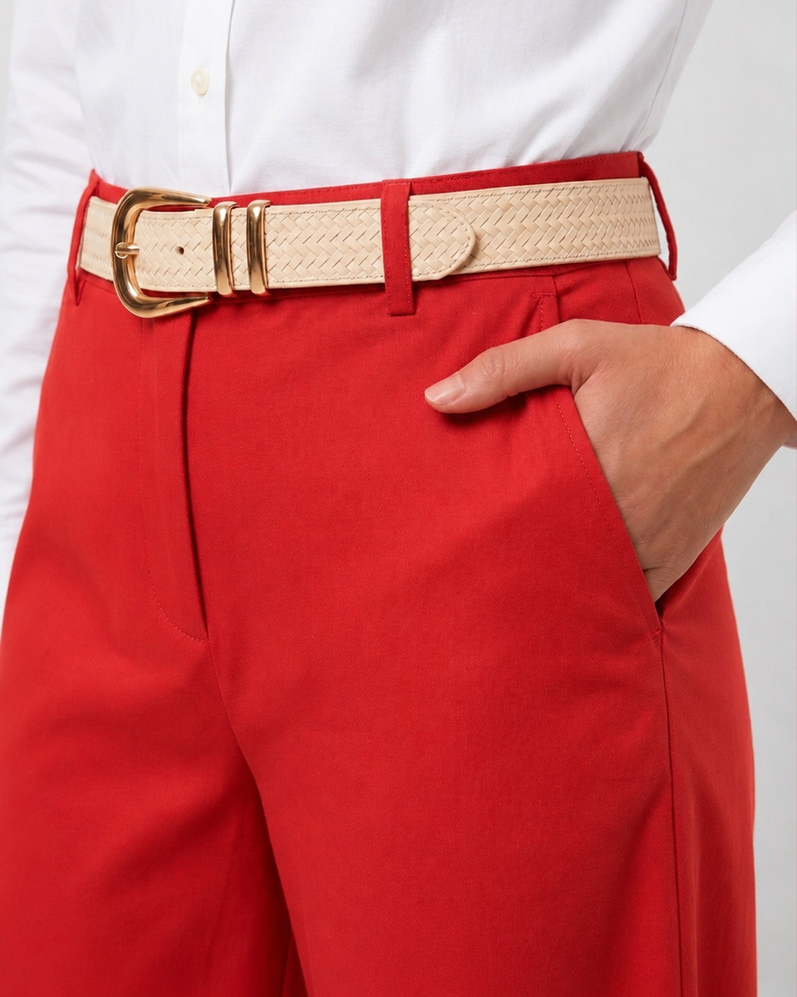 Close-up of Garnet scarlet red cotton pants waistband, belt loops and a slanted pocket