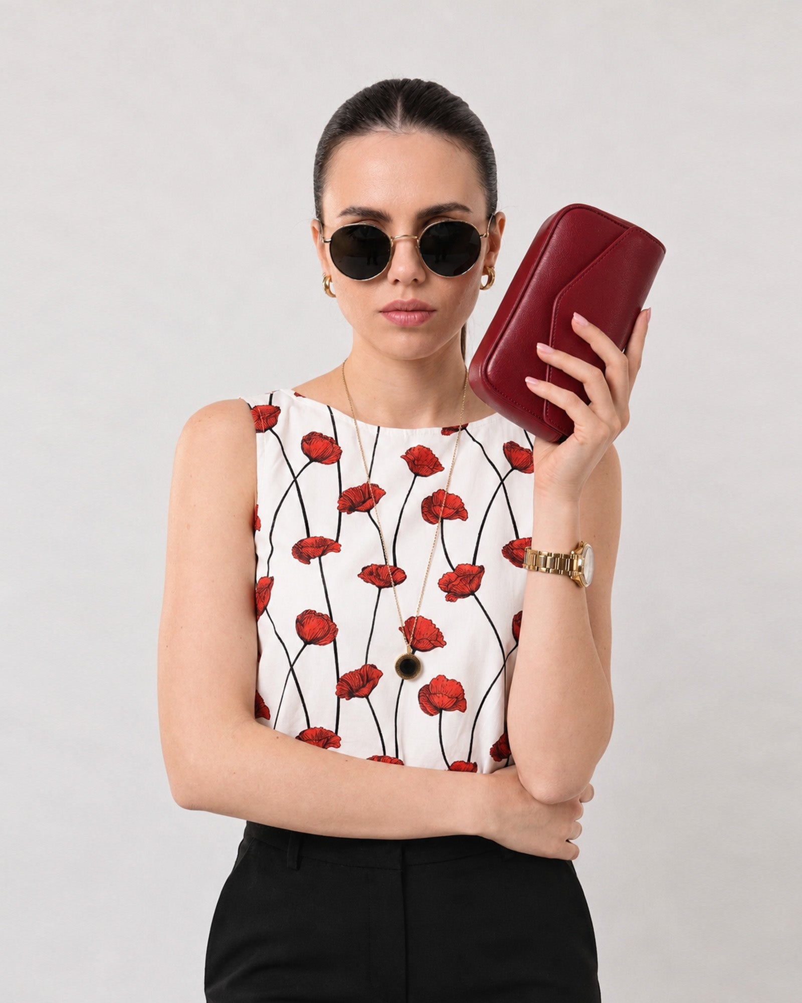 Close-up of Gaya red and white poppy print top boat neckline and sleeveless armhole