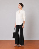 Gemini beige linen tunic top with shoulder pleats and a band collar, angled view