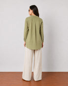 Gemini moss green linen tunic top, back view showing the yoke pleat and curved hem
