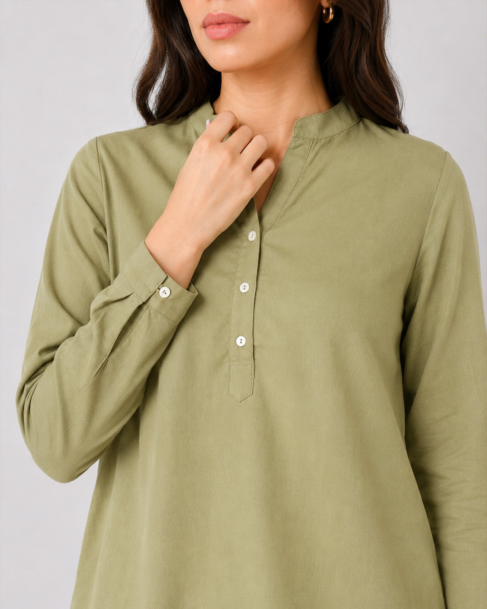 Close-up of Gemini moss green linen tunic split V-neckline, band collar and button placket