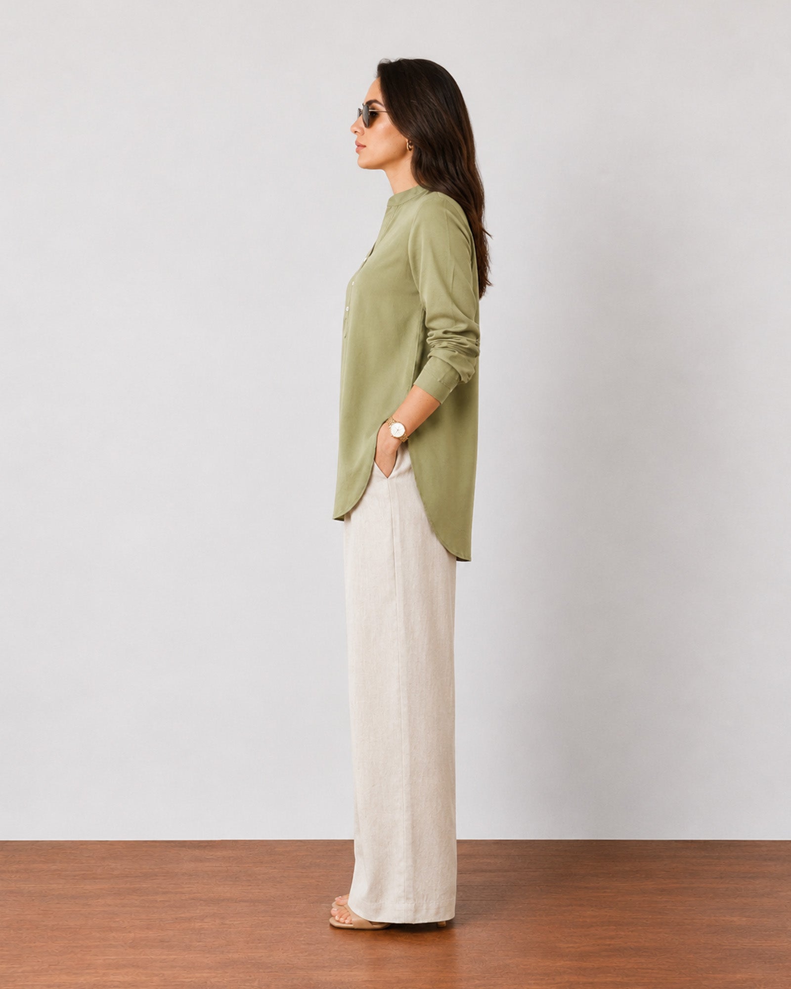 Gemini moss green breathable linen tunic top, side profile showing the curved side-split hem