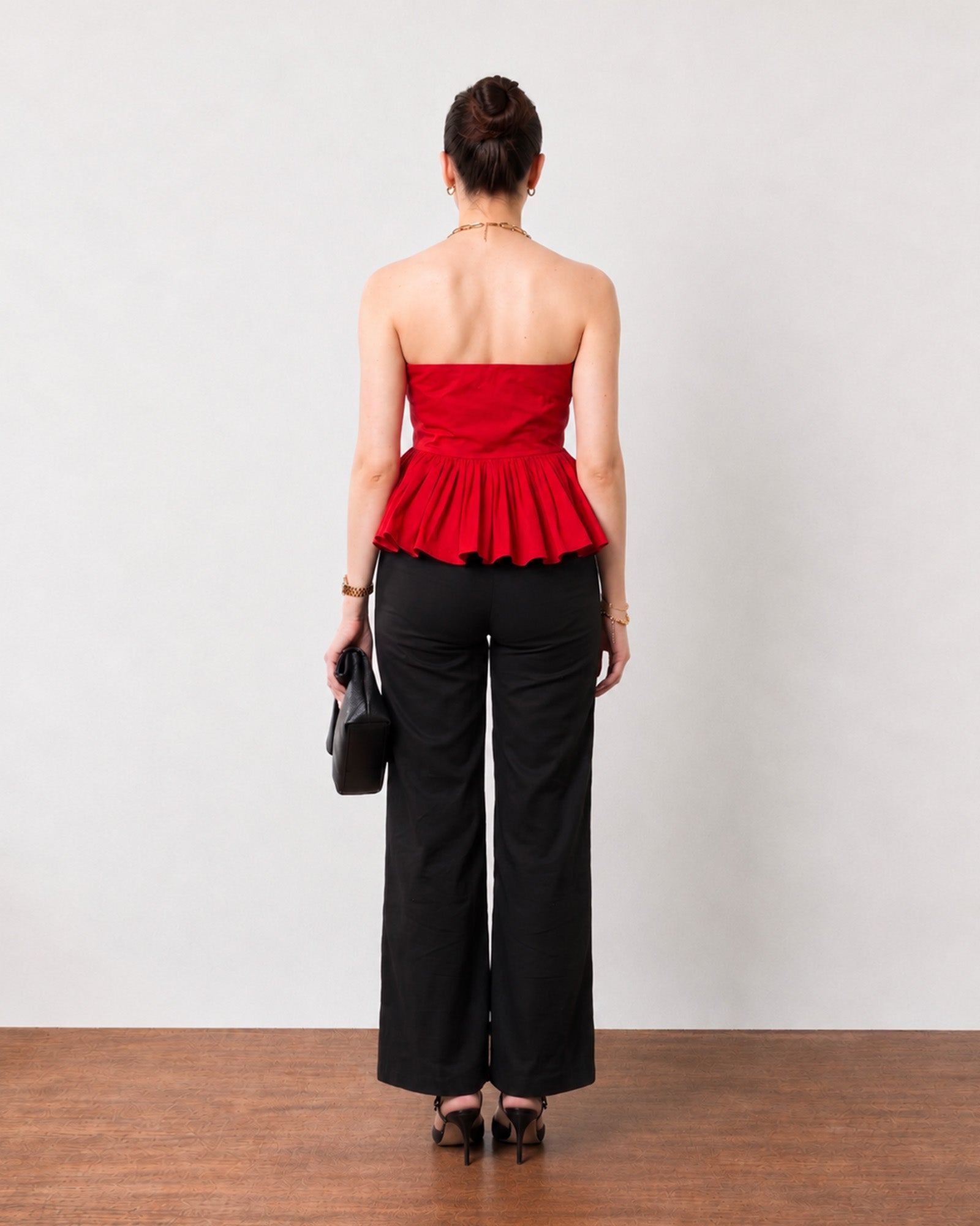 Gemma scarlet red strapless top, back view showing the full-length zip and gathered peplum