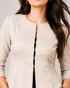 Close-up of Georgia beige blazer round neckline and hook-and-eye front closure