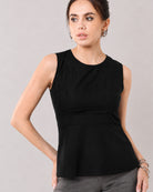 Gianna black linen top with a fitted waist and softly flared hem, front detail