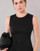 Close-up of Gianna black linen top round neckline, panel seams and waist band