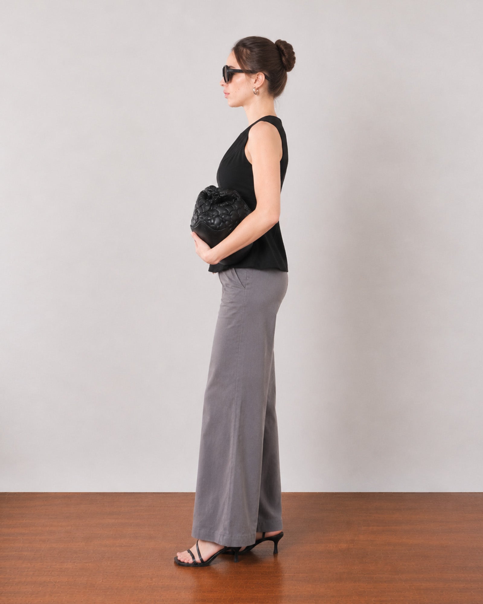 Gianna black breathable lyocell linen top, side profile showing the flared peplum hem