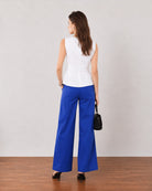 Gianna white linen top, back view showing panel seams and a softly flared hem