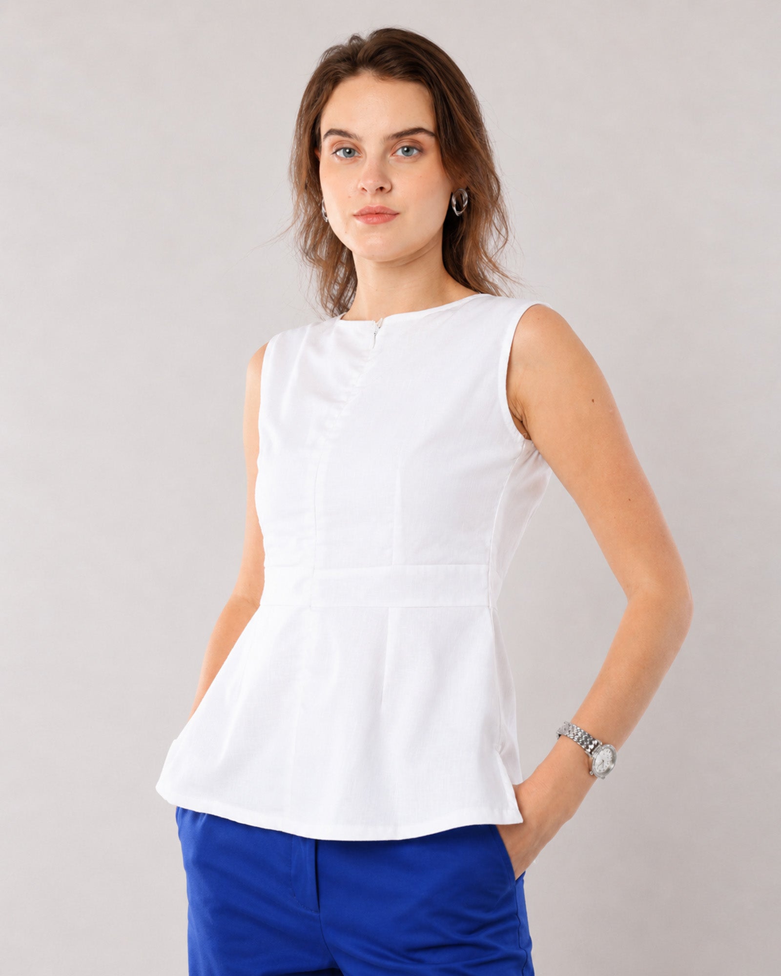 Gianna white linen top with a fitted waist and softly flared hem, front detail