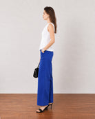 Gianna white breathable lyocell linen top, side profile showing the flared peplum hem