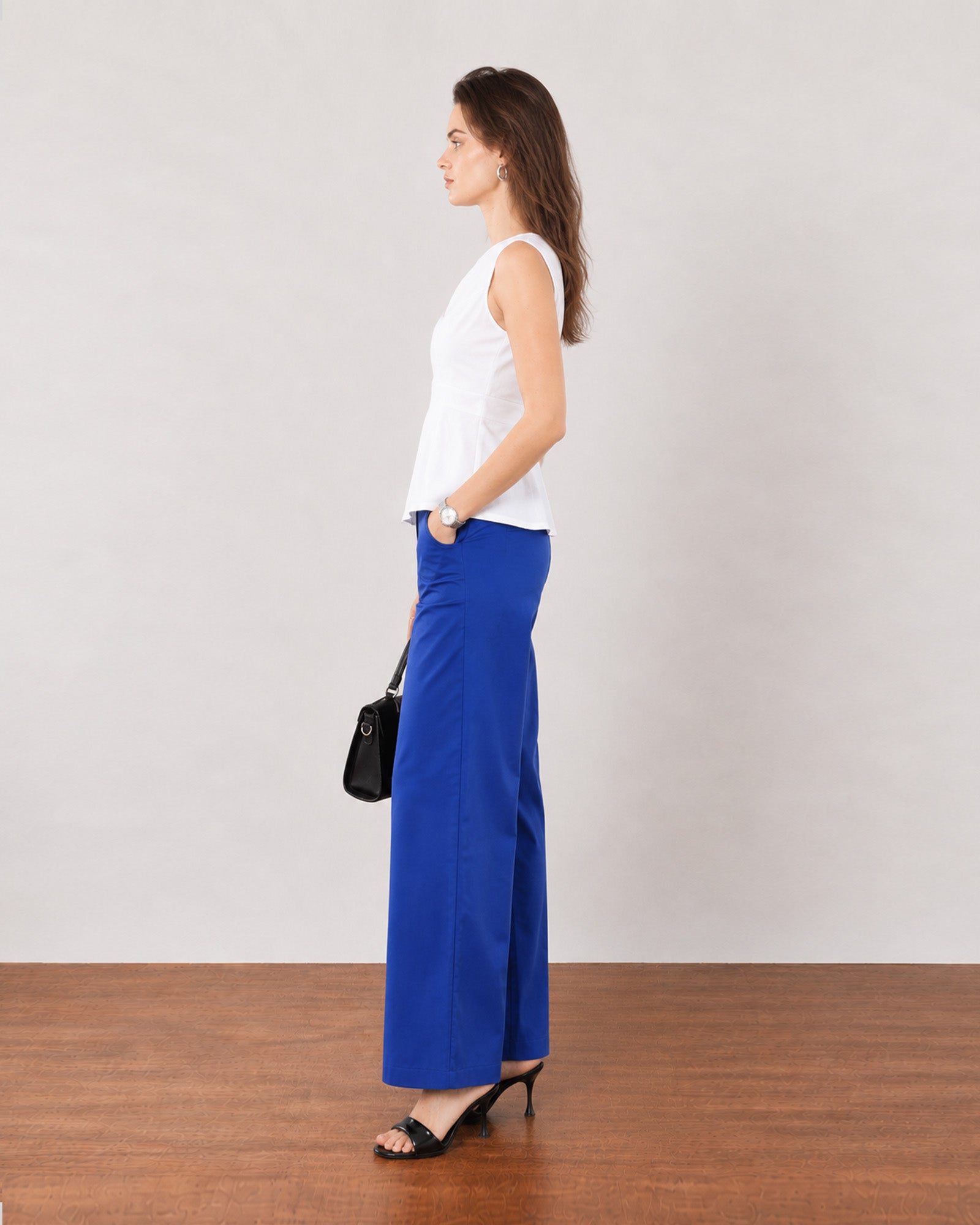 Gianna white breathable lyocell linen top, side profile showing the flared peplum hem