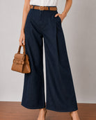 Close-up of Gigi indigo blue denim pants waistband and double front pleats