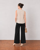 Gill beige linen top, back view showing the relaxed fit and broad flared hemline